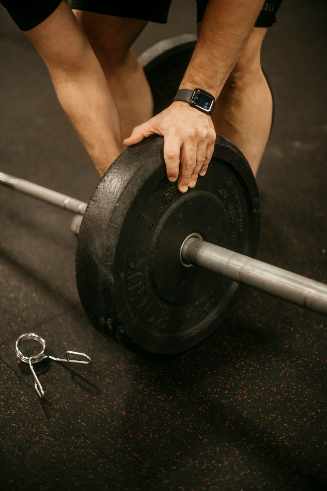 a-man-lifting-a-barbell-with-a-pair-of-scissors-z0xdndofc3k